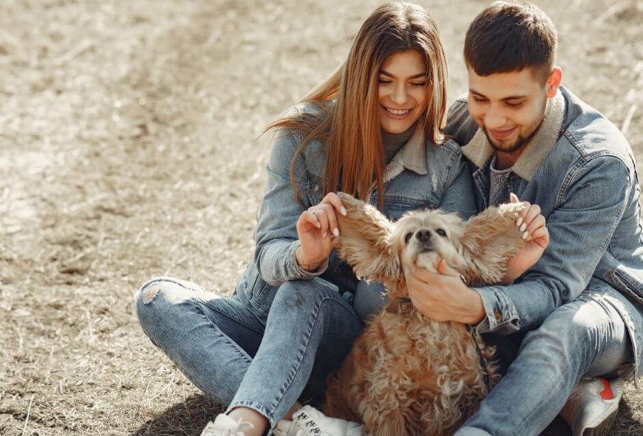 Couple and dog on the ground