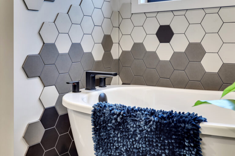 Home interior charcoal and white tile detail behind bathtub